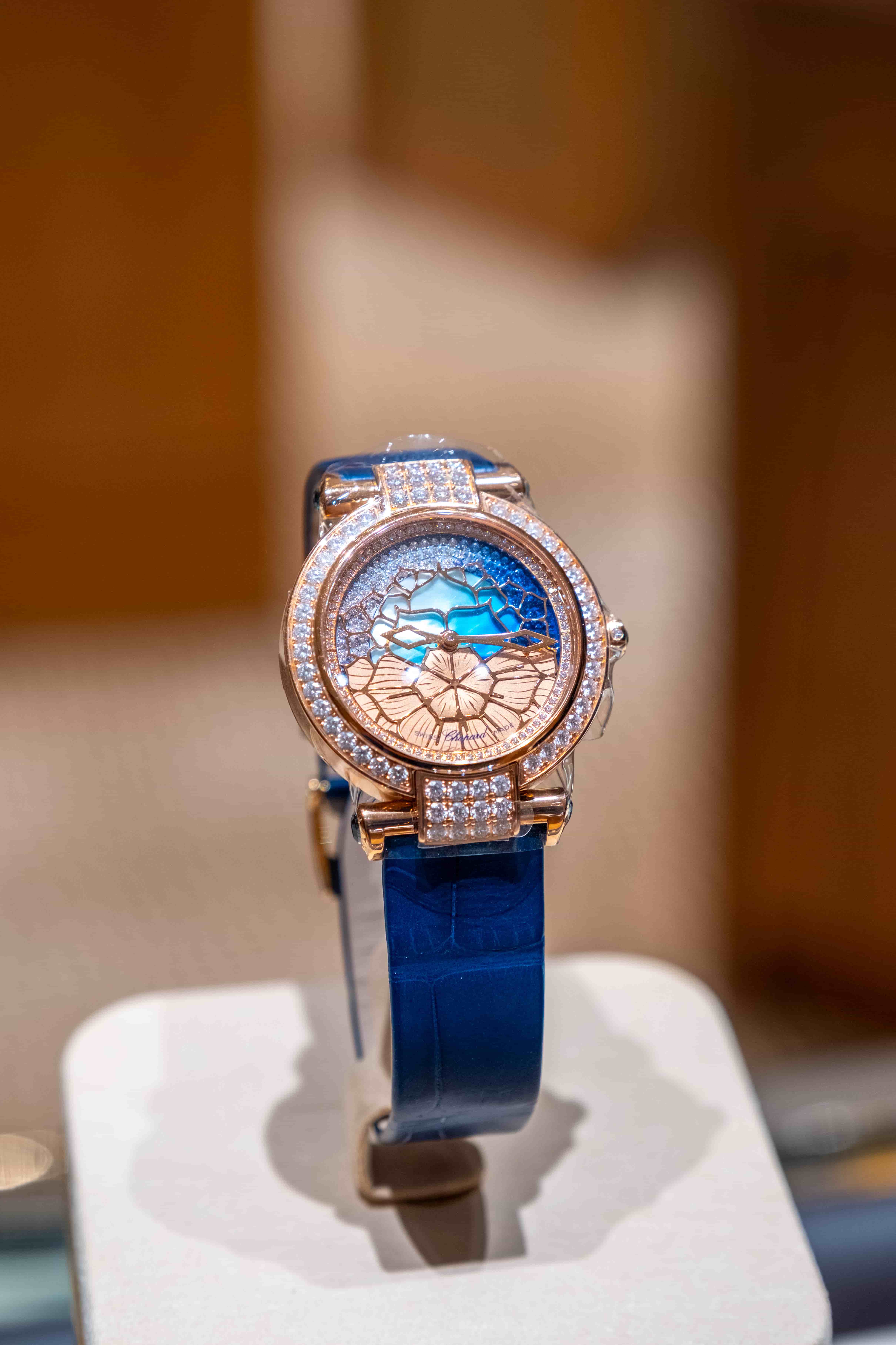 Chopard Imperiale watch with an intricate blue sunray dial, gold-toned filigree patterns, and a diamond-encrusted rose gold bezel.