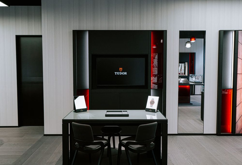 A black and red office with a desk and tv.