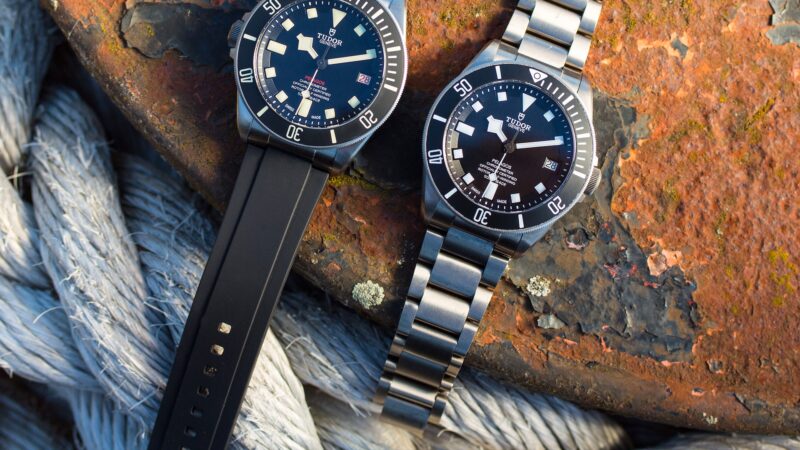 Two tudor watches sitting next to each other.