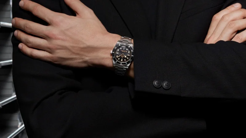 A man in a suit is wearing a watch.
