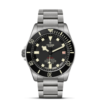 A M25610TNL-0001 tudor black dial watch on a black background.