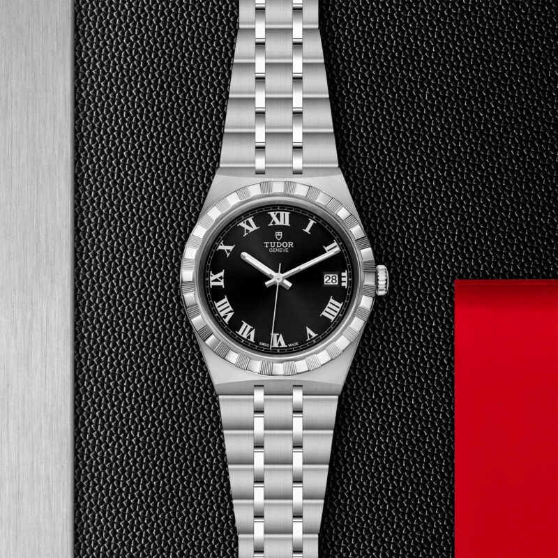 A M28500-0003 watch with roman numerals on a black background.