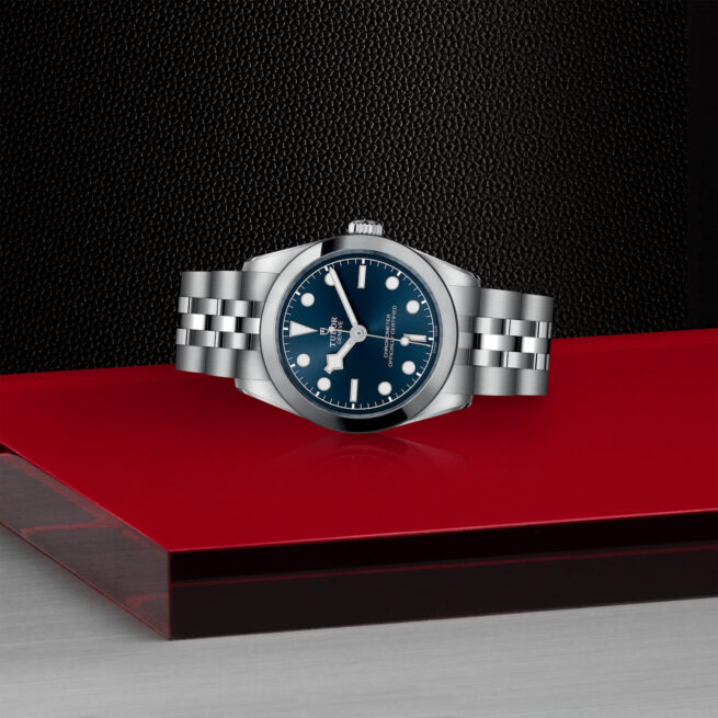 A M79600-0002 watch on a red table.