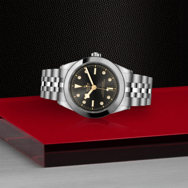 A M79660-0004 with a black dial on a red table.