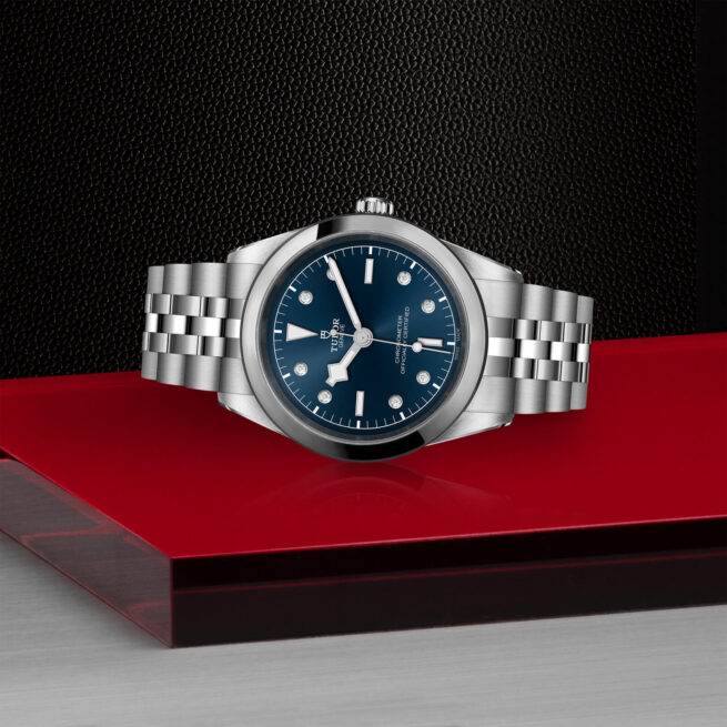 A M79680-0005 watch on a red table.