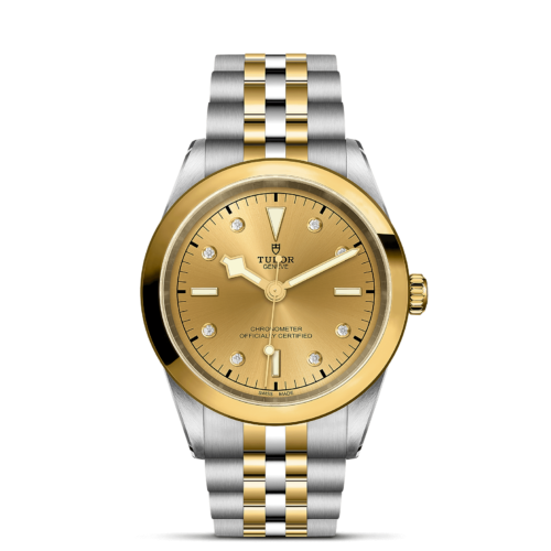 The M79683-0008 gold and diamond watch on a black background.