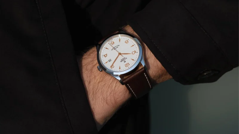 A man's wrist with a watch on it.