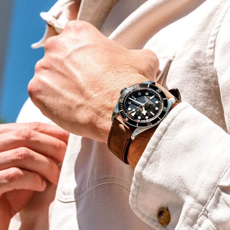 A man wearing a watch with a brown leather strap. Product Name: M79030N-0002