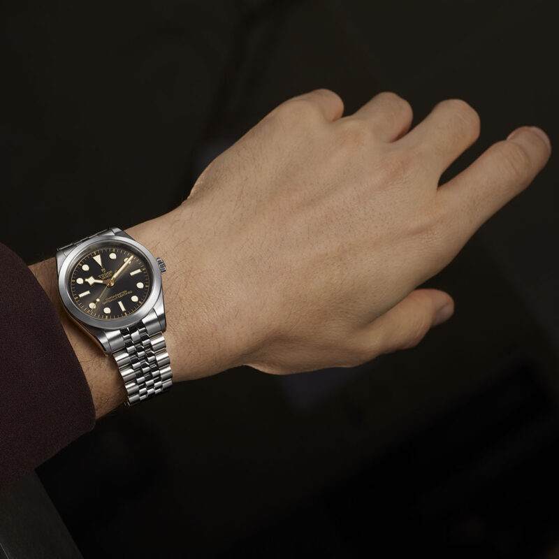 A man's wrist with a M79680-0001 watch on it.
