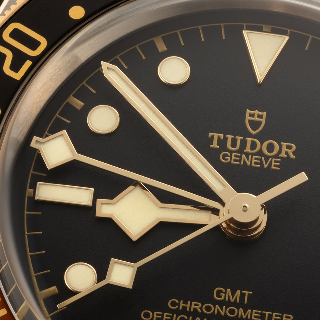 A close up of a M79833MN-0004 watch with a gold dial.