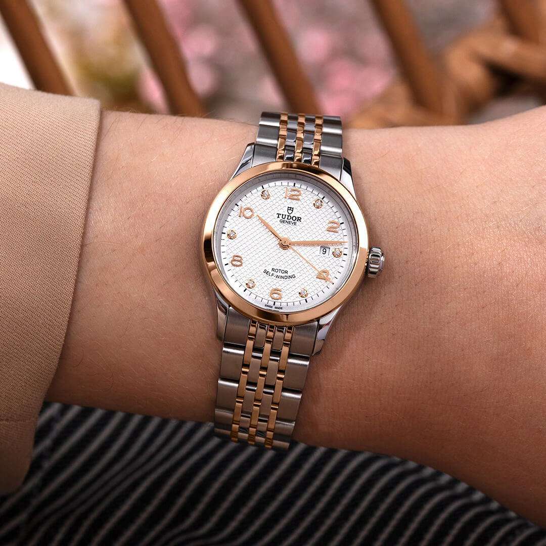 A woman's wrist with a M91651-0012 watch.