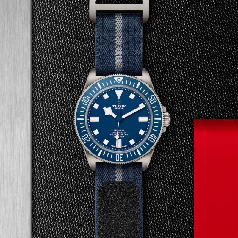 A M25707B-0001 watch with a blue strap on a black background.