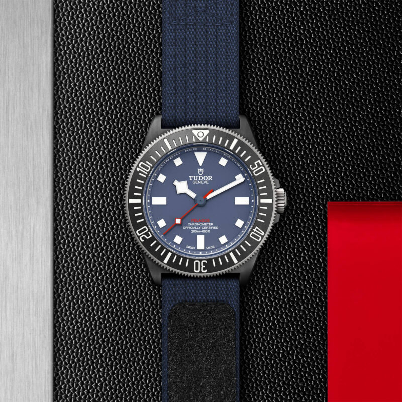 A M25707KN-0001 watch with a red, blue, and black strap.