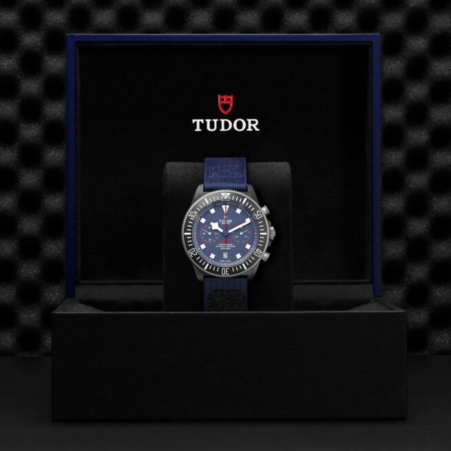 A M25807KN-0001 watch in a box with a blue strap.
