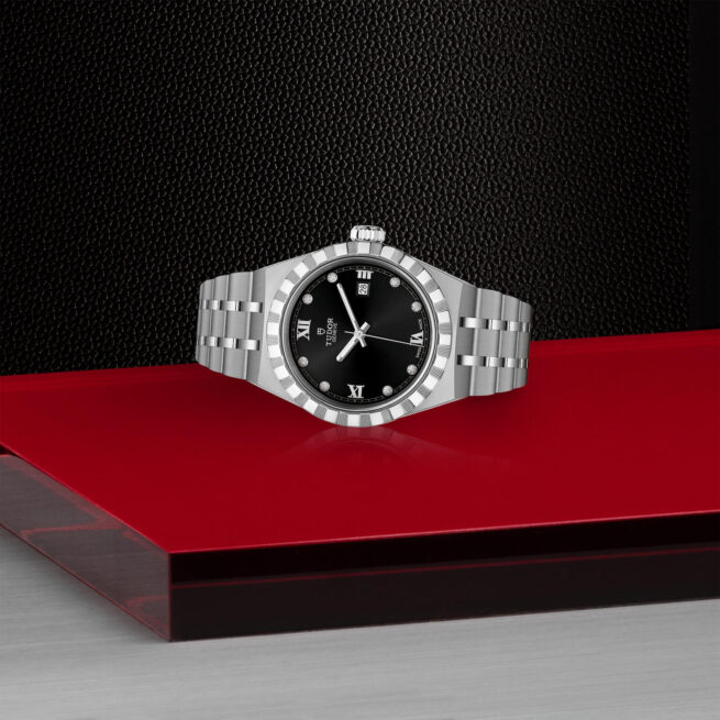 A M28300-0004 oyster watch on a red table.