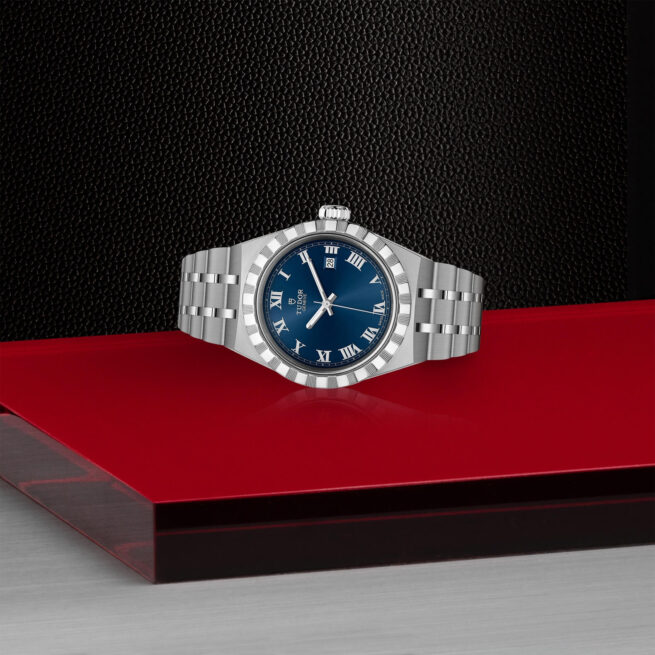A M28300-0006 watch on a red table.