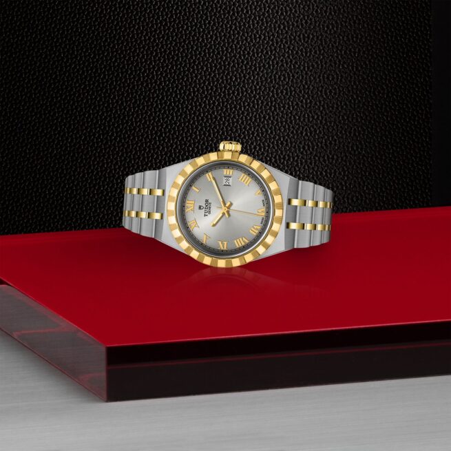 A M28303-0001 ladies watch sitting on a red table.