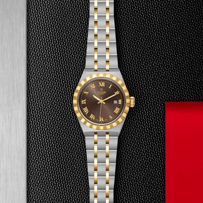 A M28303-0008 with a brown dial on a black background.