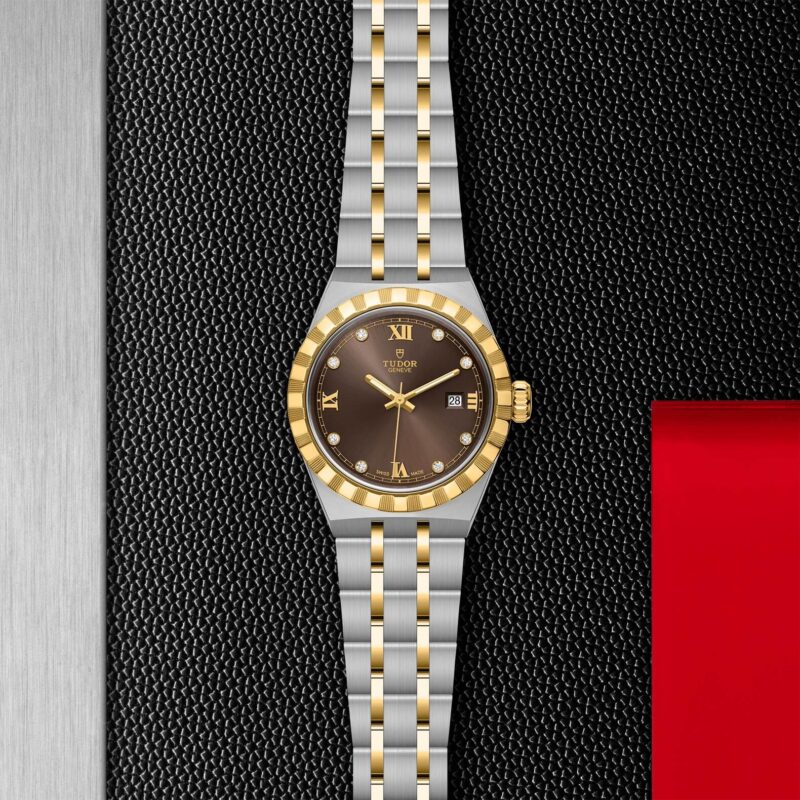 A M28303-0009 watch with a brown dial on a black background.