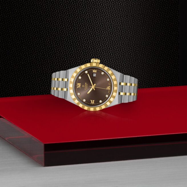 A M28303-0009 tudor watch on a red table.