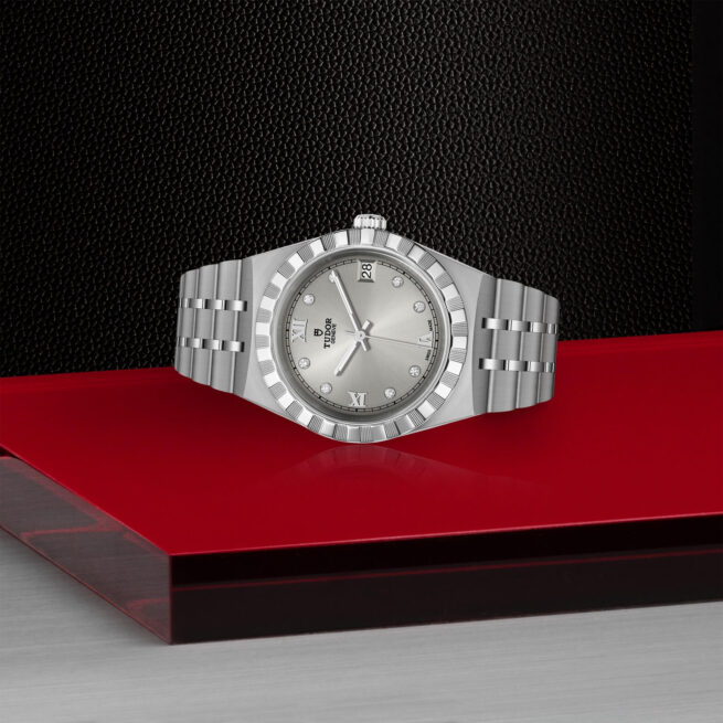 A M28400-0002 watch sitting on a red surface.