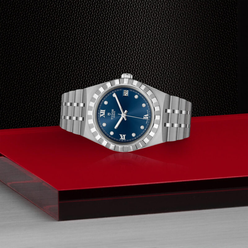 A M28400-0007 watch with blue dial sitting on a red table.