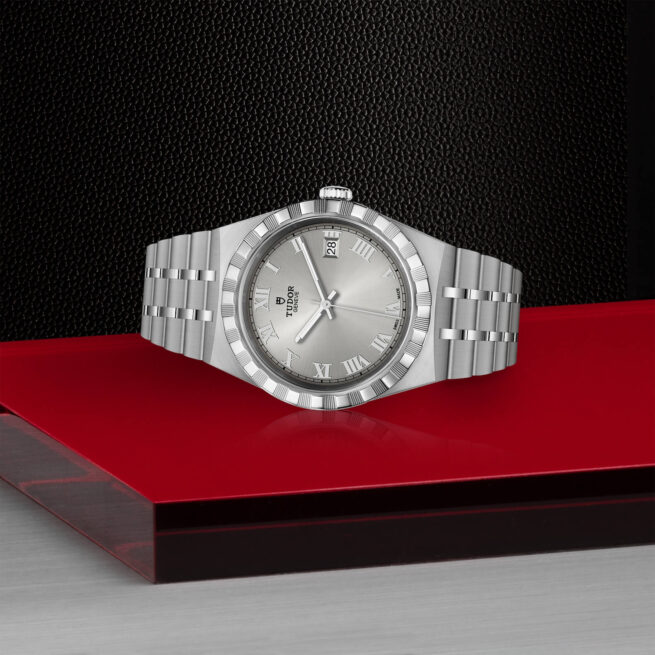 A M28500-0001 watch sitting on a red table.