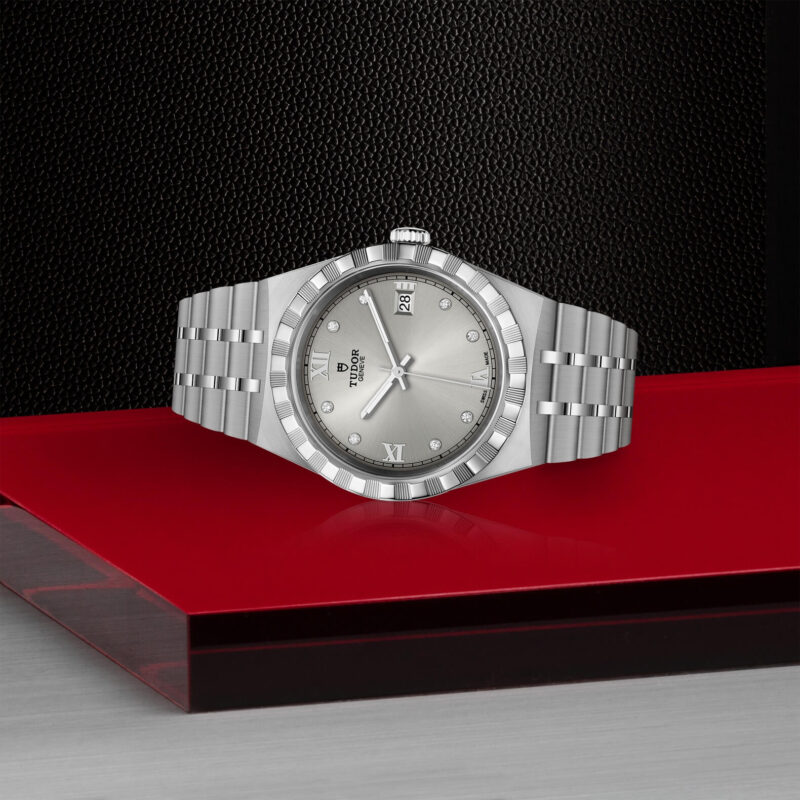 A M28500-0002 watch sitting on a red table.