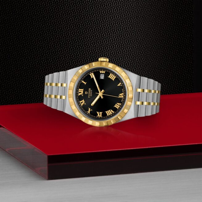 A M28503-0006 watch with roman numerals on a red background.
