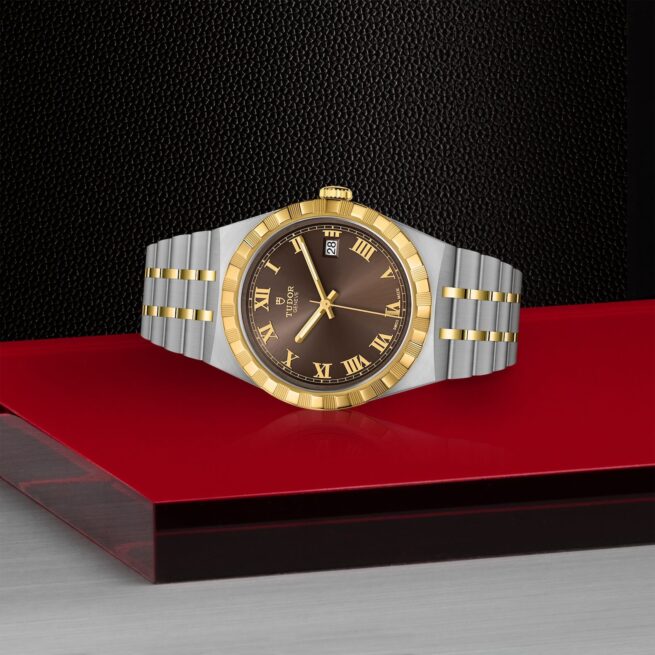 A M28503-0007 watch with roman numerals on a red background.