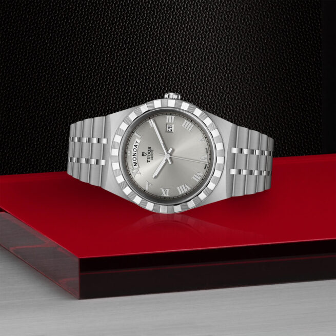 A M28600-0001 watch sitting on a red surface.