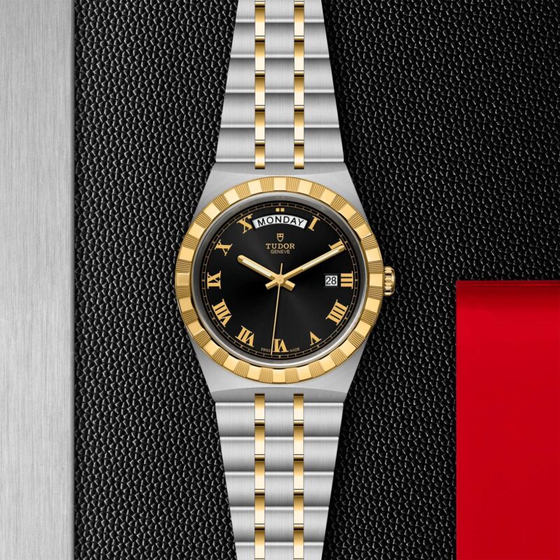 A M28603-0003 watch with roman numerals on a black background.