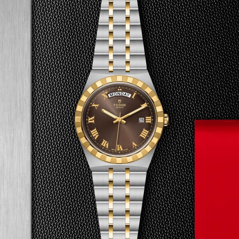 A M28603-0007 watch with roman numerals on a black background.