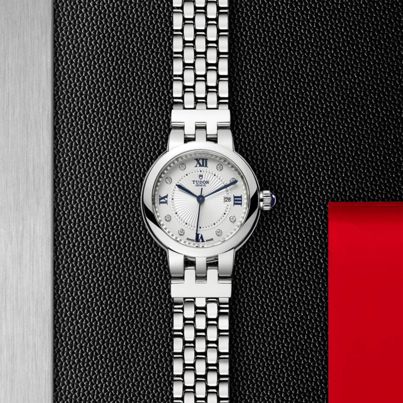 A women's watch (M35500-0004) on a red leather strap.