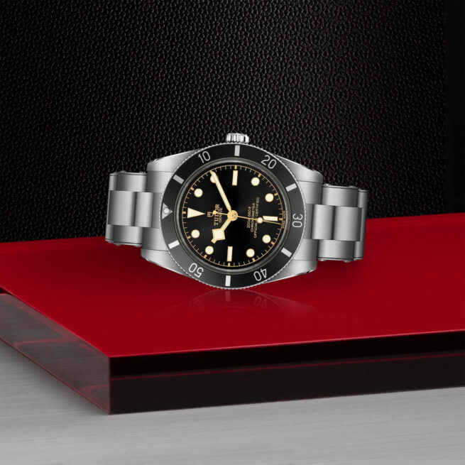 A M79000N-0001 black bay watch on a red table.
