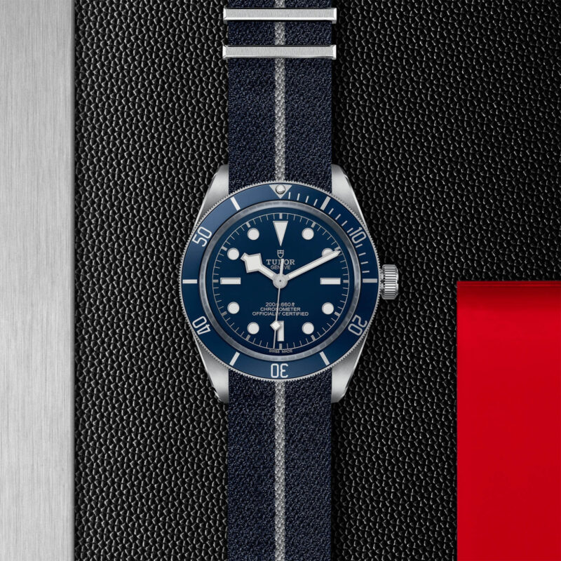 A M79030B-0003 watch with a blue strap on a black background.