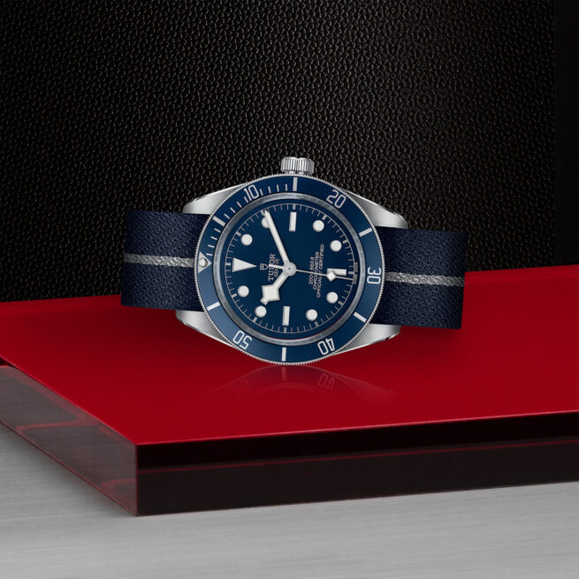 tudor M79030B-0003 bay watch on a red table.