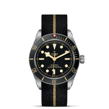The M79030N-0003 watch on a black background.