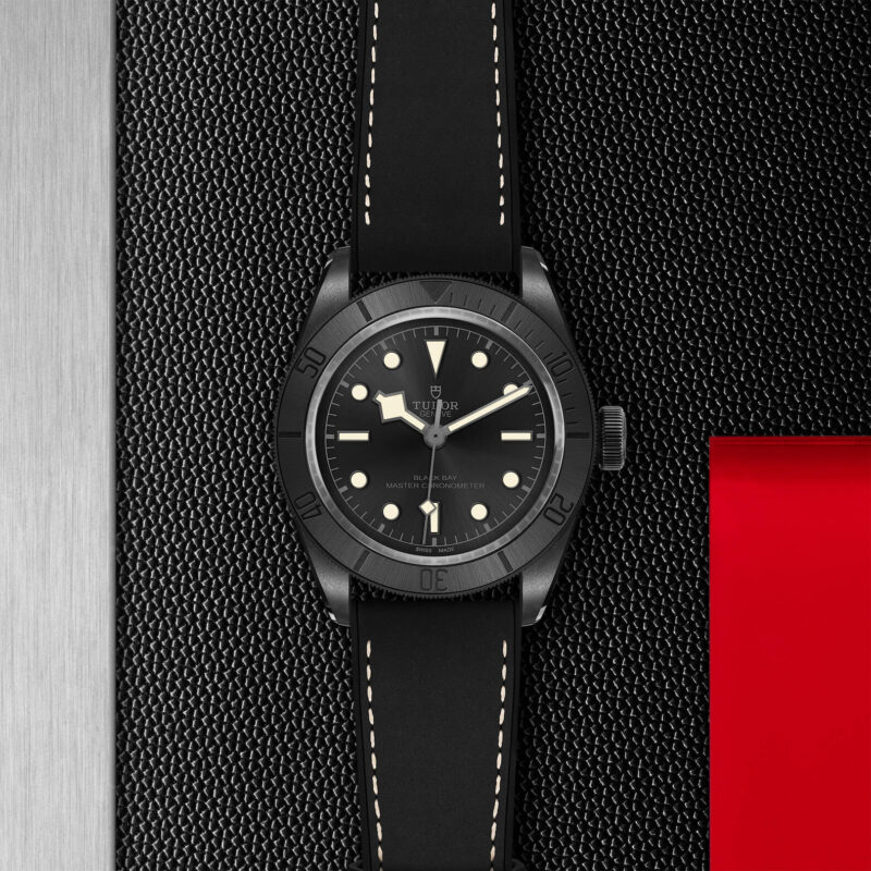 A M79210CNU-0001 watch on a red background.