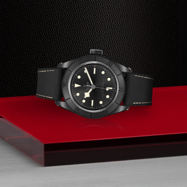 A M79210CNU-0001 watch on a red table.