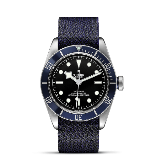 The M79230B-0006 wristwatch features a dark blue band and a black face. Its bezel is marked with minute indicators, and the watch boasts a silver crown. The face includes hour markers, hands, and a brand logo.