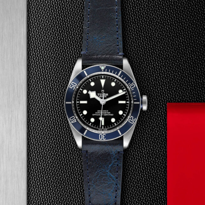 A M79230B-0006 watch on a black leather strap.