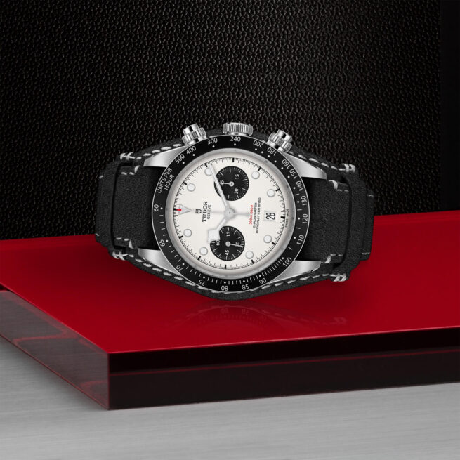 Sentence with the product name: A M79360N-0005 watch sitting on a red surface.