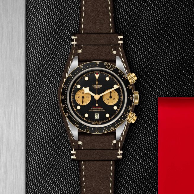 The M79363N-0002 chronograph is sitting on a red and black background.