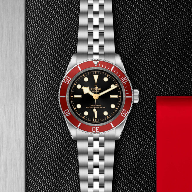 A tudor M7941A1A0RU-0003 watch with a red bezel.