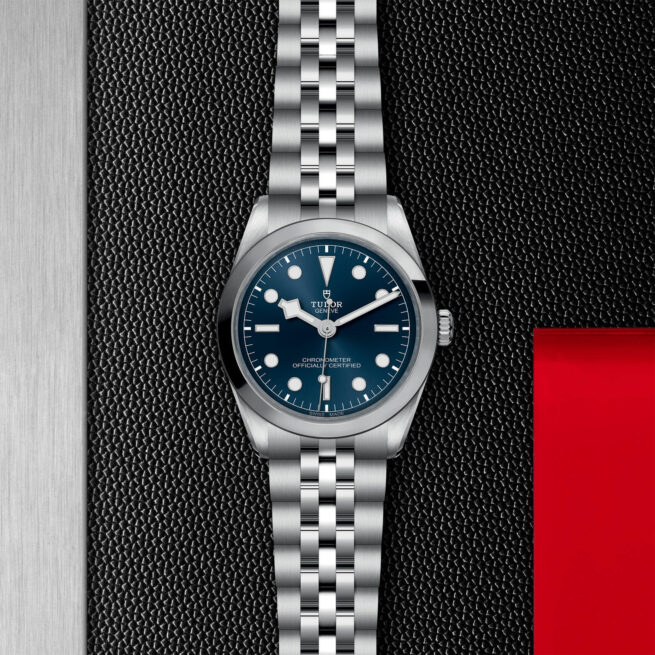 A M79640-0002 watch on a black leather strap.