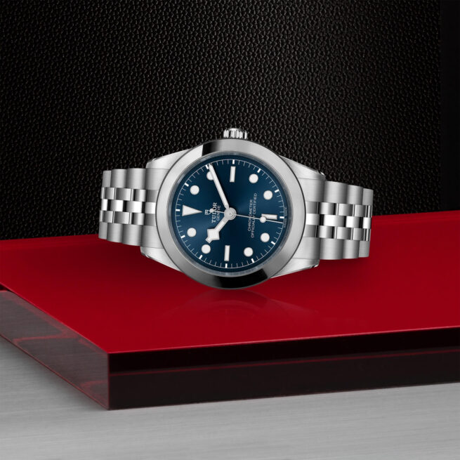 A M79660-0002 watch on a red table.