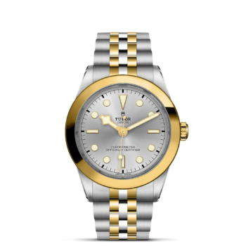 A M79663-0002 watch with a gold and silver dial.