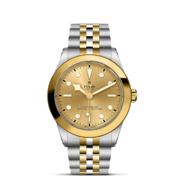A M79663-0005 yellow gold watch on a black background.