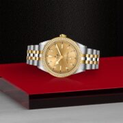 A M79673-0007 watch on a red table.